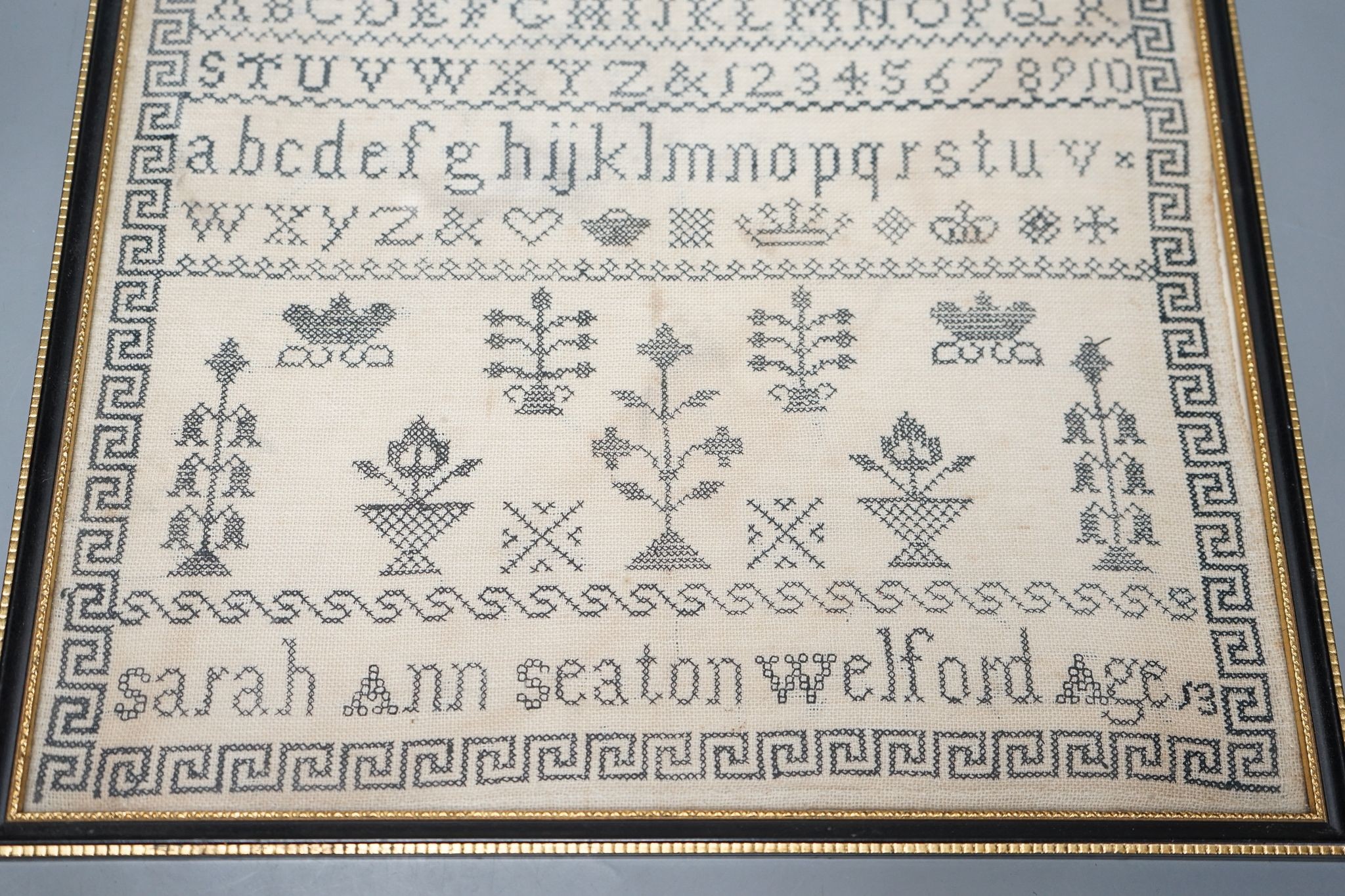 A framed Victorian alphabet sampler by Sarah Ann Seaton Welford, aged 13, 32x33cm